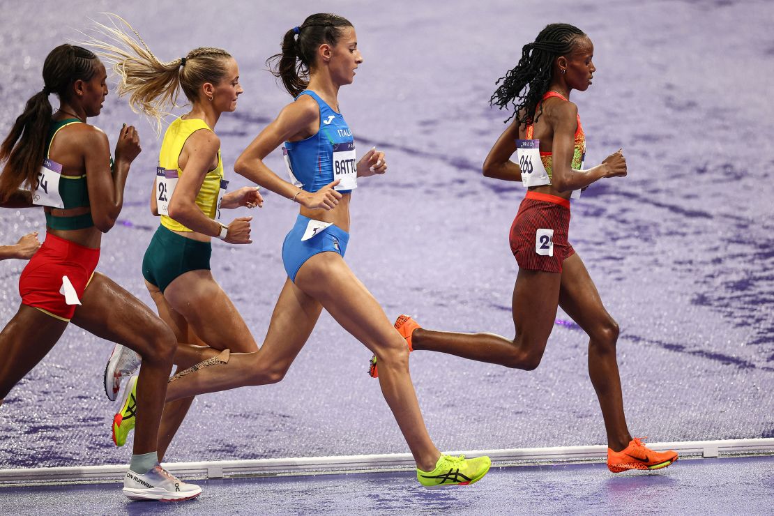 Kenya's Beatrice Chebet leads ahead of Italy's Nadia Battocletti in the women's 10000m final of the athletics event at the Paris 2024 Olympic Games at Stade de France in Saint-Denis, north of Paris, on August 9, 2024. (Photo by Anne-Christine POUJOULAT / AFP) (Photo by ANNE-CHRISTINE POUJOULAT/AFP via Getty Images)