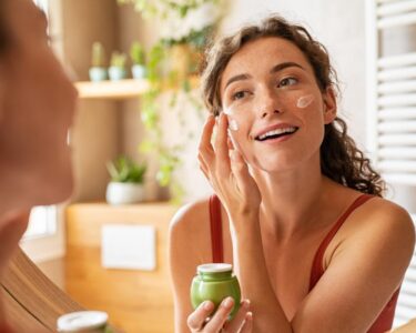 A person putting a facial ointment on.