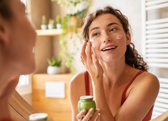 A person putting a facial ointment on.