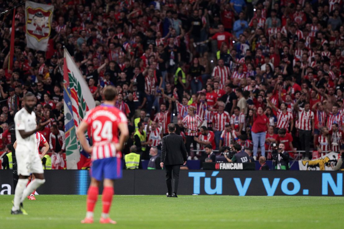 Atlético manager Diego Simeone spoke to fans after objects were thrown onto the pitch.