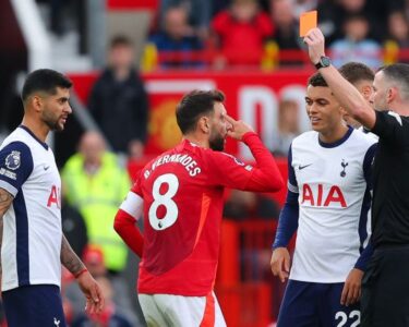 Tottenham players celebrate their third goal against United.