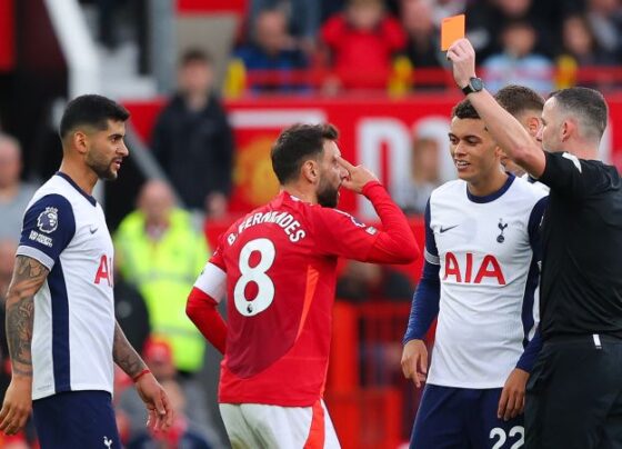 Tottenham players celebrate their third goal against United.