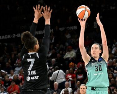 Sabrina Ionescu drives past Las Vegas Aces guard Jackie Young during the New York Liberty's game against the Las Vegas Aces.