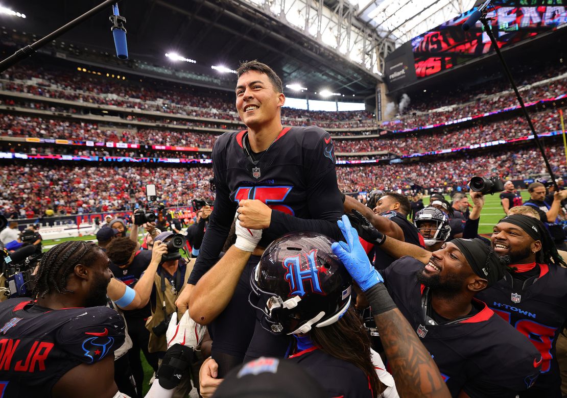 Fairbairn is lifted by teammates after kicking the game-winning field goal against the Bills.