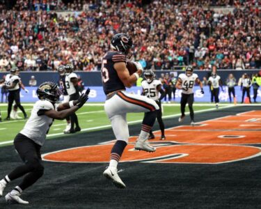 Lawrence hands the ball off during the game.