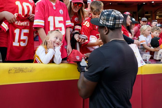 New Orleans Saints linebacker Willie Gay Jr. signs autographs for a young Kansas City Chiefs fan before the start of the game between the teams in Kansas City, Missouri, on Monday, October 7. Gay played for the Chiefs for four seasons before signing with the Saints during the offseason. The Chiefs beat the Saints 26-13.