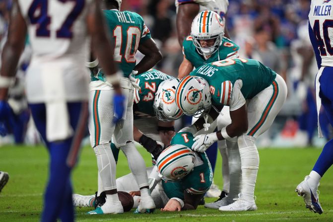 Miami Dolphins players attend to quarterback Tua Tagovailoa after he took a hit to the head in the second half of a game against the Buffalo Bills in Miami Gardens, Florida, on Thursday, September 12. Tagovailoa was later ruled out with a concussion.