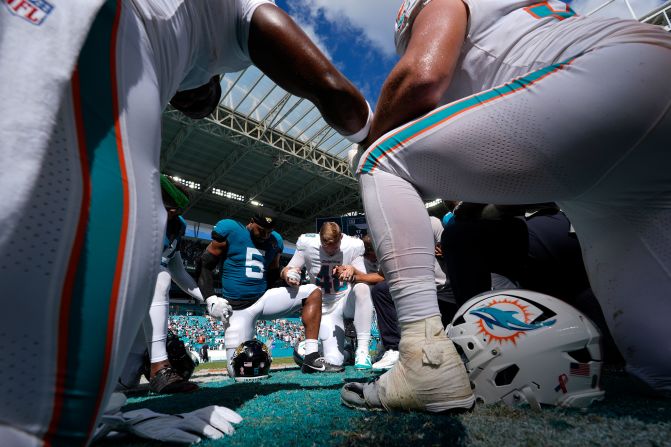 Miami Dolphins and Jacksonville Jaguars players pray together at the end of the game in Miami Gardens, Florida, on September 8.