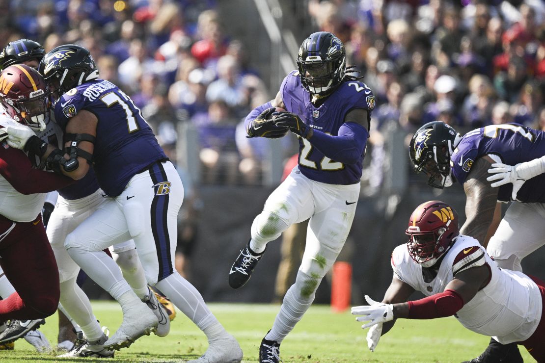 Oct 13, 2024; Baltimore, Maryland, USA; Baltimore Ravens running back Derrick Henry (22) rushes through the hole during the first half against the Washington Commanders at M&T Bank Stadium. Mandatory Credit: Tommy Gilligan-Imagn Images