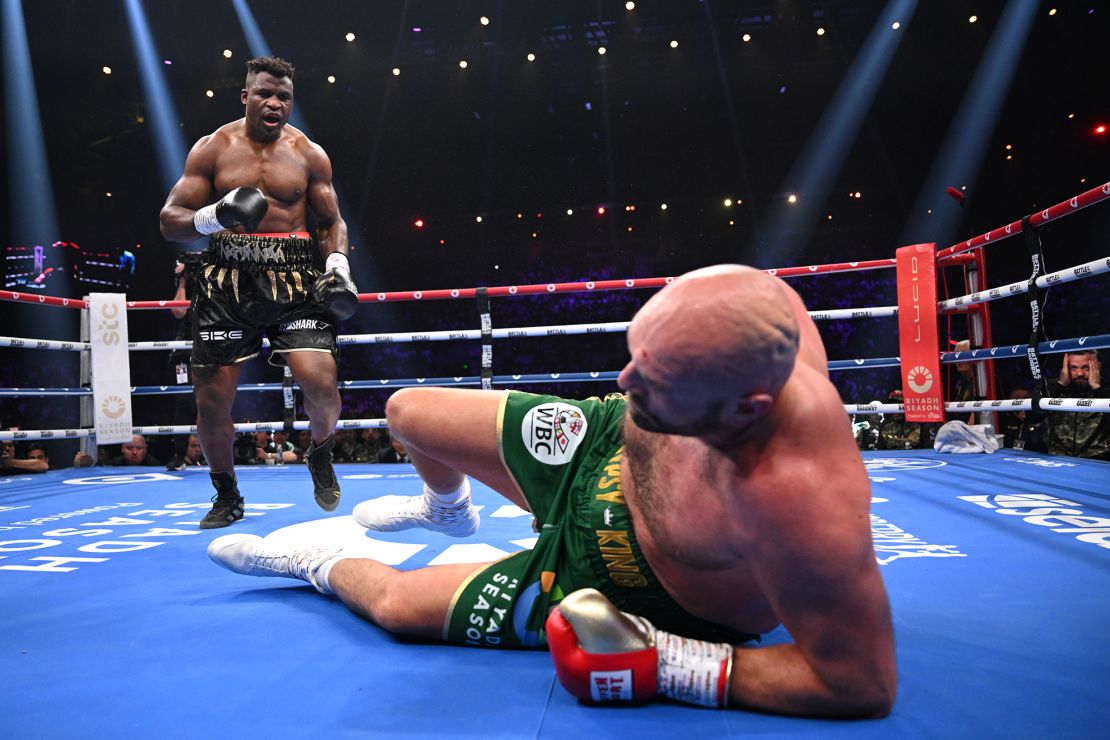 Francis Ngannou knocks down Tyson Fury during their heavyweight fight at Boulevard Hall on October 28, 2023, in Riyadh, Saudi Arabia.