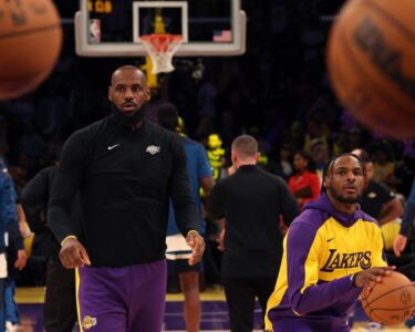 Bronny James and LeBron James warm up prior to the game against the Minnesota Timberwolves.