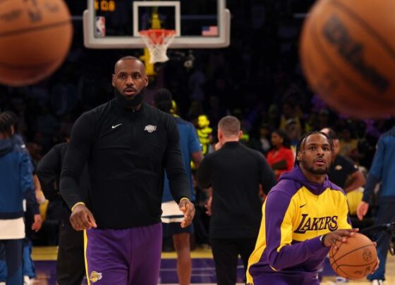 Bronny James and LeBron James warm up prior to the game against the Minnesota Timberwolves.