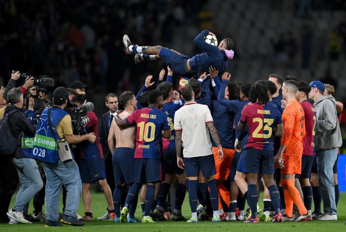 Raphinha is thrown in the air by his Barcelona teammates after scoring a hat-trick against Bayern Munich.