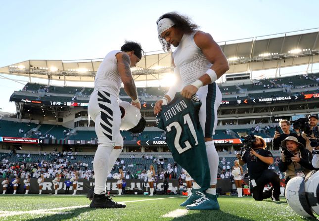 Cincinnati Bengals running back Chase Brown, left, and his identical twin brother, Philadelphia Eagles safety Sydney Brown, exchange jerseys after the game between their teams in Cincinnati on October 27. The Eagles won 37-17.