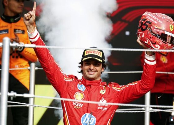 Sainz celebrates on the podium with Lando Norris and teammate Charles Leclerc.