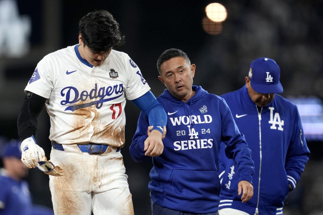 Shohei Ohtani is helped off the field after getting hurt during the seventh inning in Game 2 of the World Series against the New York Yankees.