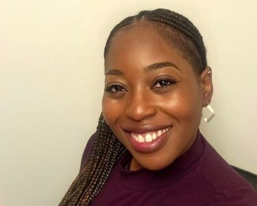 A headshot of a woman smiling.