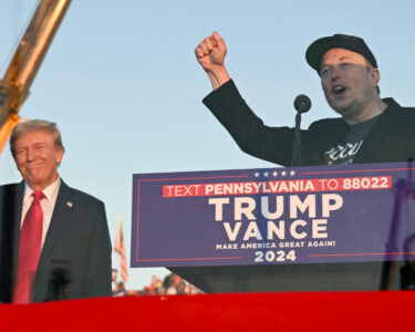 Tesla CEO Elon Musk (R) speaks on stage as he joins former US President and Republican presidential candidate Donald Trump during a campaign rally at site of his first assassination attempt in Butler, Pennsylvania on October 5, 2024. (Photo by Jim WATSON / AFP) (Photo by JIM WATSON/AFP via Getty Images)