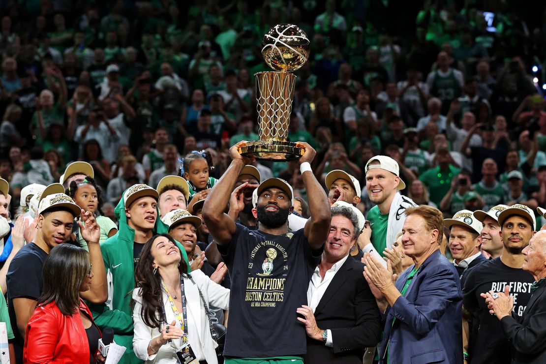 Jaylen Brown lifts the Larry O’Brien Trophy after beating the Dallas Mavericks in the NBA Finals.