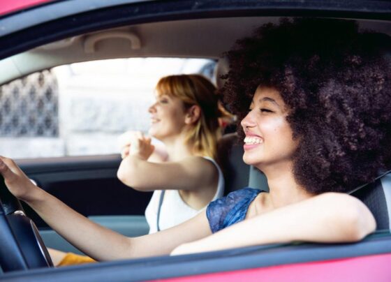 Two happy people in a car enjoying the tunes.