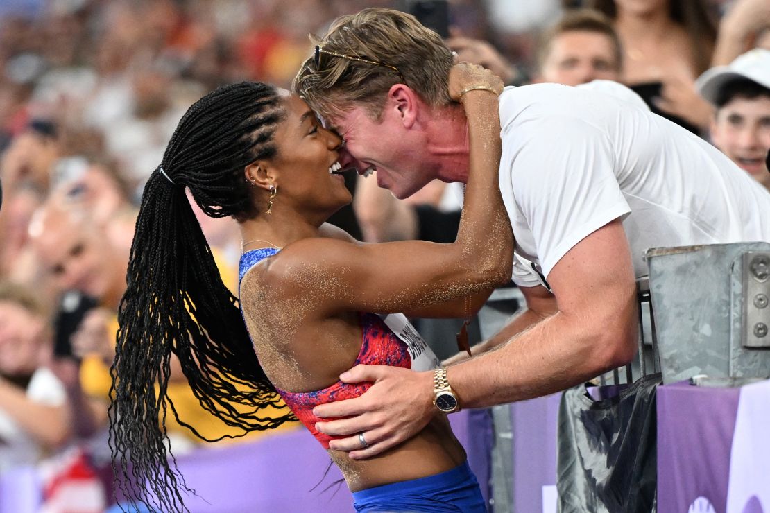 TOPSHOT - Gold medallist US' Tara Davis-Woodhall (L) celebrates with her husband US' track and field paralympic athlete Hunter Woodhall (R) after winning the women's long jump final of the athletics event at the Paris 2024 Olympic Games at Stade de France in Saint-Denis, north of Paris, on August 8, 2024. (Photo by Kirill KUDRYAVTSEV / AFP) (Photo by KIRILL KUDRYAVTSEV/AFP via Getty Images)