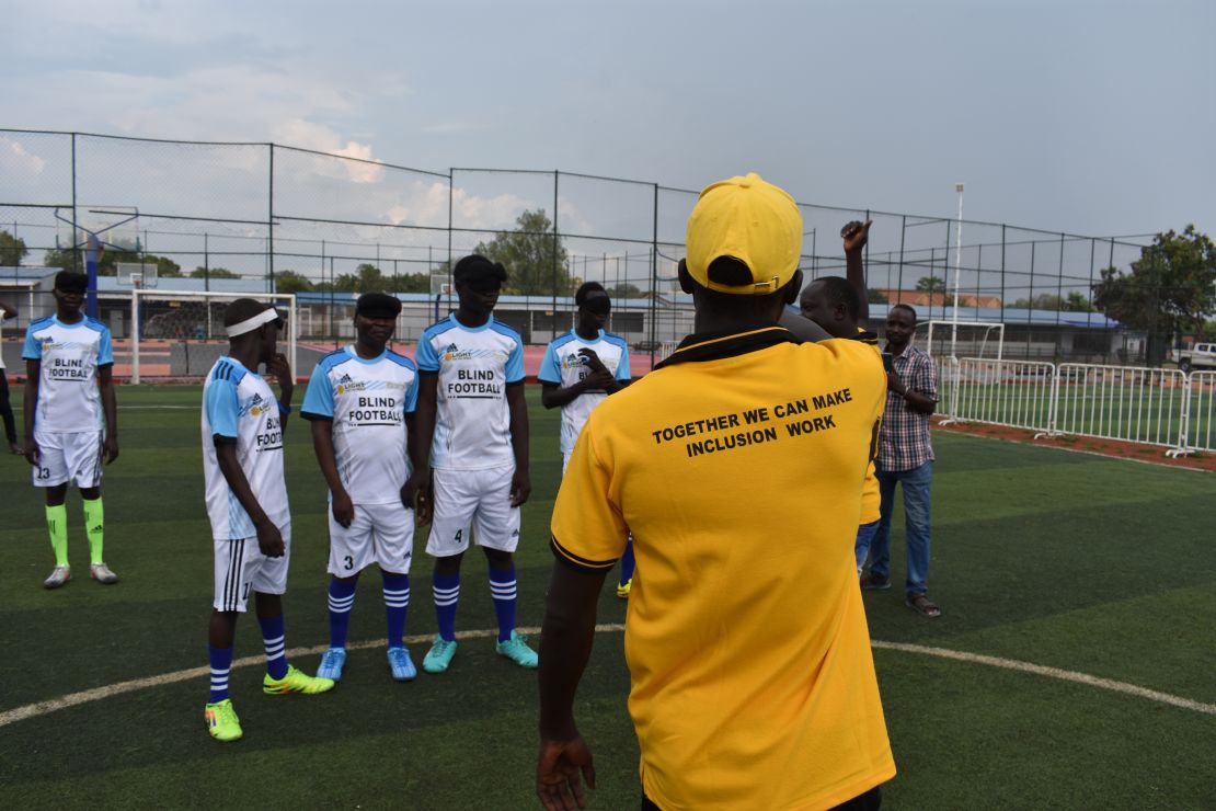 A coach delivers instructions to players ahead of a match.