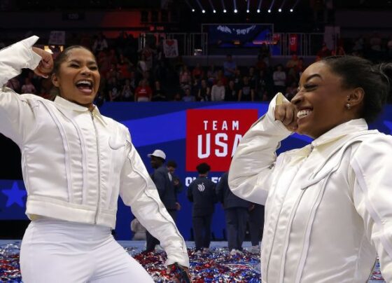 Jordan Chiles, with Simone Biles behind her, watches the competition during the women's team gymnastics final of the 2024 Paris Olympics.