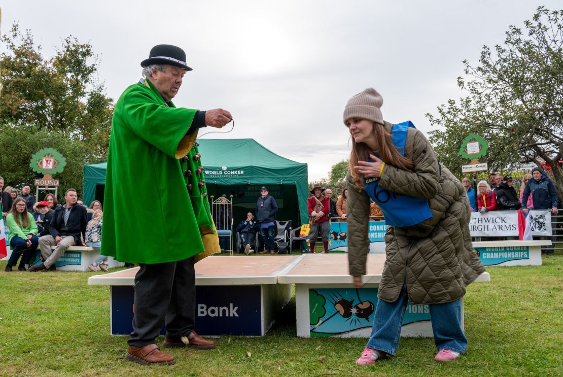 Kelci Banschbach takes a swing at David Jakins’ conker during the overall final.