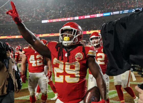 Buccaneers quarterback Baker Mayfield and Chiefs running back Kareem Hunt embrace after a hard-fought game.