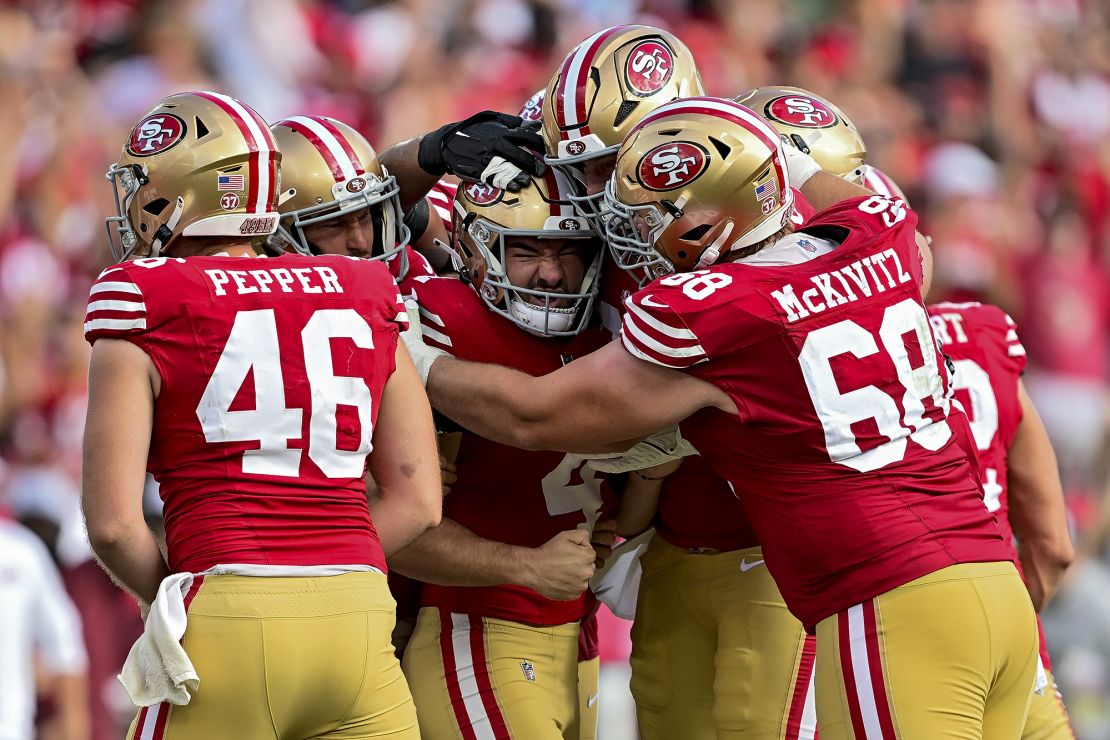 Moody (middle) celebreates with his 49ers teammates after scoring the game-winning field goal against the Buccaneers.