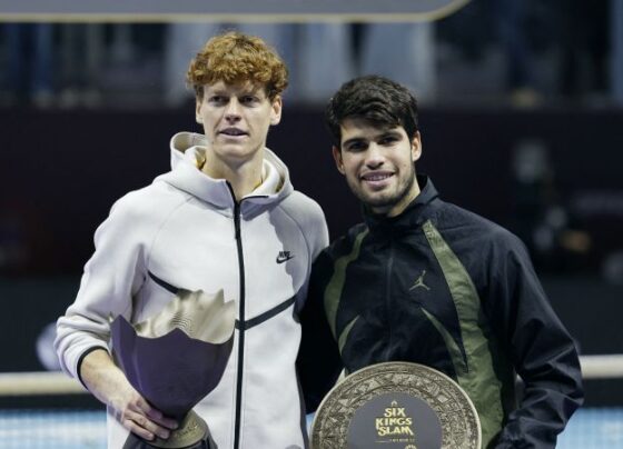 Italy's Jannik Sinner posses with the trophy after winning the Six Kings Slam over Carlos Alcaraz.