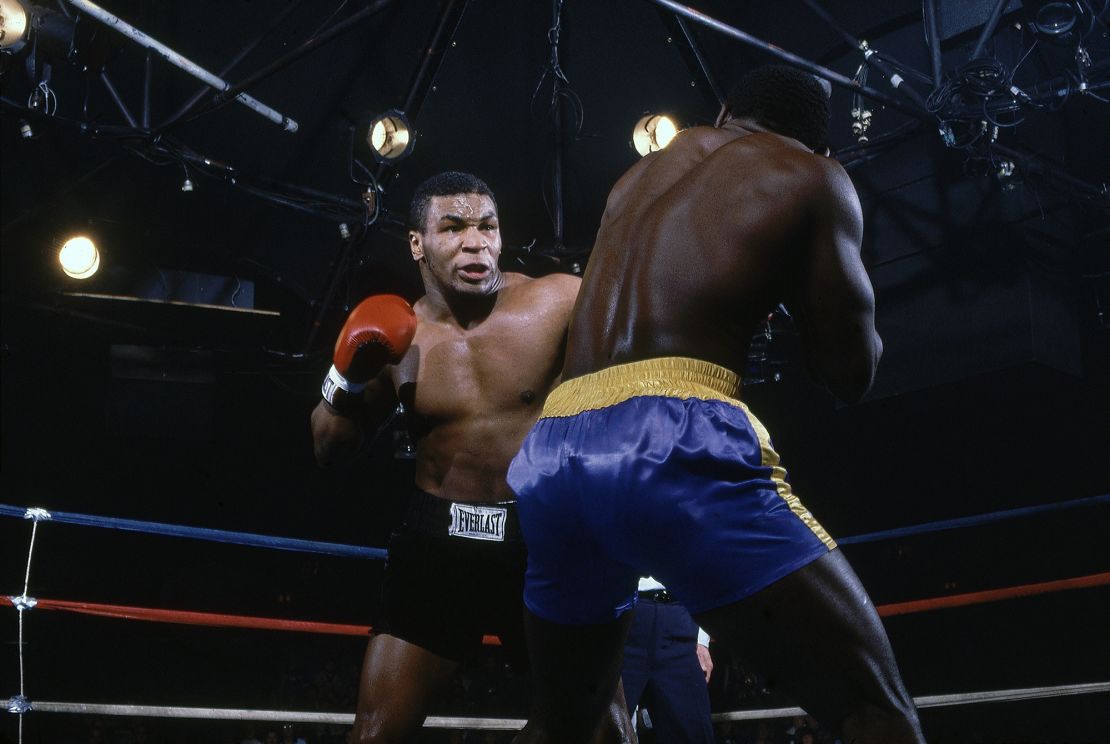 Tyson (left) burst onto the boxing scene in 1985 as an 18-year-old. He's seen here defeating Mark Young (right) at Latham Coliseum in his 15th professional fight.