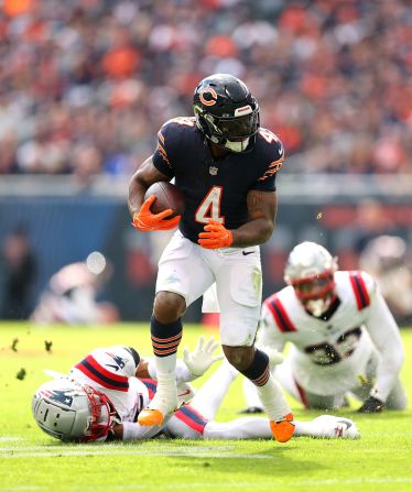 Chicago Bears running back D'Andre Swift carries the ball past New England Patriots cornerback Marco Wilson and linebacker Anfernee Jennings at Soldier Field in Chicago on November 10. The Bears lost 19-3.