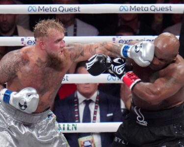 Tyson, left, and Paul fight during their heavyweight boxing match.