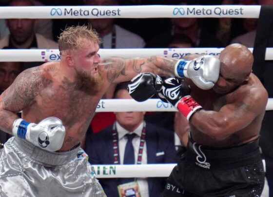 Tyson, left, and Paul fight during their heavyweight boxing match.