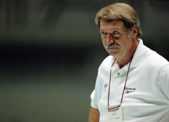 USA's Kerri Strug is carried by her coach, Bela Karolyi, as she waves to the crowd on her way to receiving her gold medal for the women's team gymnastics competition, at the Centennial Summer Olympic Games in Atlanta, July 23, 1996.