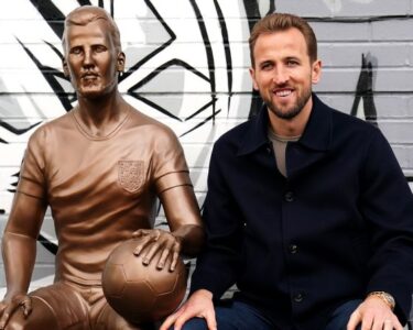 Harry Kane next to his statue at the unveiling on Monday.