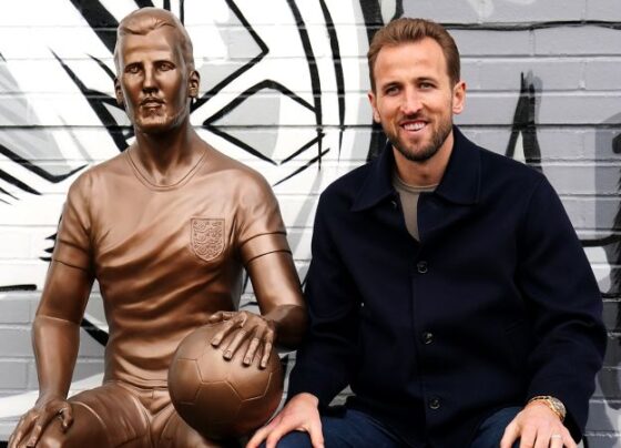 Harry Kane next to his statue at the unveiling on Monday.