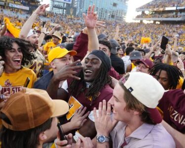 Fans rushed the field prematurely as one second was put back on the game clock after an official review.