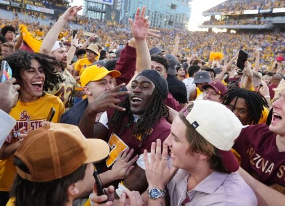 Fans rushed the field prematurely as one second was put back on the game clock after an official review.