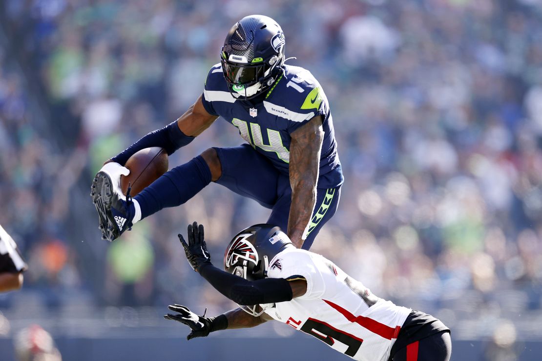 SEATTLE, WASHINGTON - SEPTEMBER 25: DK Metcalf #14 of the Seattle Seahawks jumps over Casey Hayward #29 of the Atlanta Falcons during the second quarter at Lumen Field on September 25, 2022 in Seattle, Washington. (Photo by Steph Chambers/Getty Images)