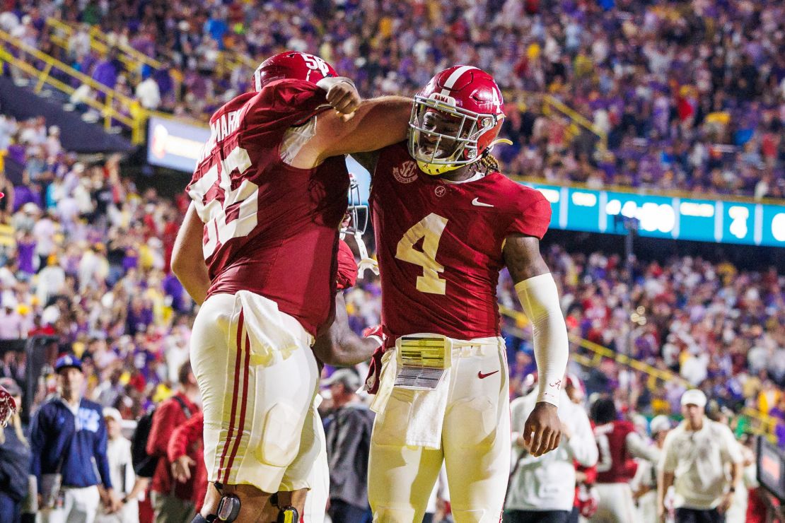 Alabama Crimson Tide quarterback Jalen Milroe (4) celebrates a touchdown with offensive lineman Geno VanDeMark (56).