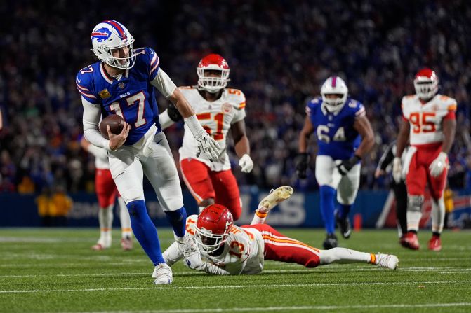 Buffalo Bills quarterback Josh Allen slips past Kansas City Chiefs cornerback Nazeeh Johnson to score on a 26-yard run near the end of the game in Orchard Park, New York, on Sunday, November 17. The Bills beat the Chiefs 30-21, ending Kansas City’s 15-game win streak. Allen finished with 262 yards, one touchdown and one interception while adding 57 yards and a score on the ground.