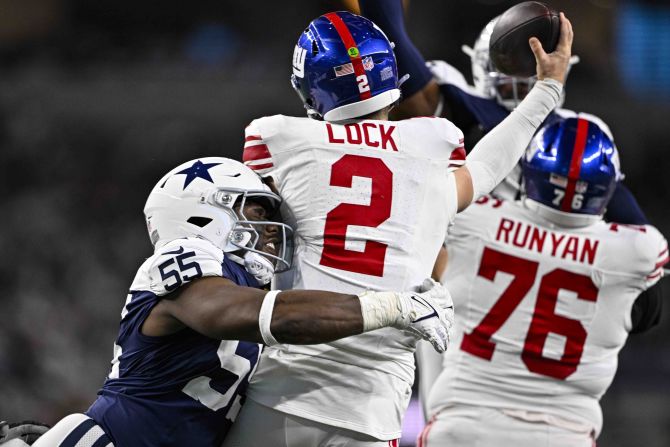 Dallas Cowboys defensive end Carl Lawson sacks New York Giants quarterback Drew Lock in Arlington, Texas, on November 28.