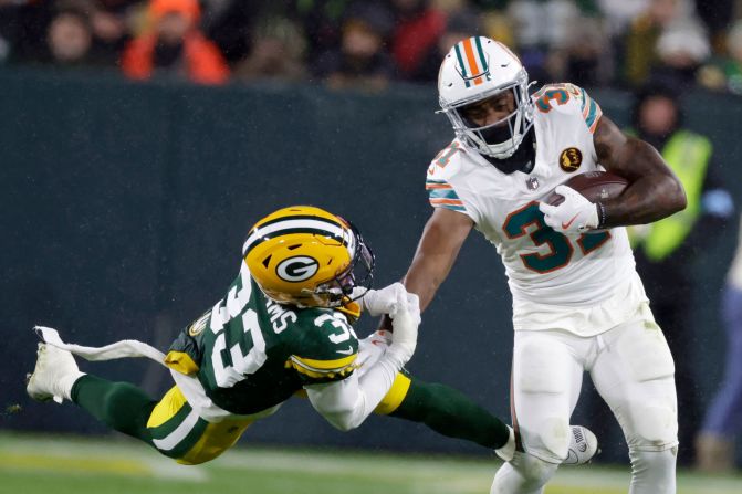 Miami Dolphins running back Raheem Mostert stiff arms Green Bay Packers safety Evan Williams in Green Bay, Wisconsin, on Thursday, November 28.