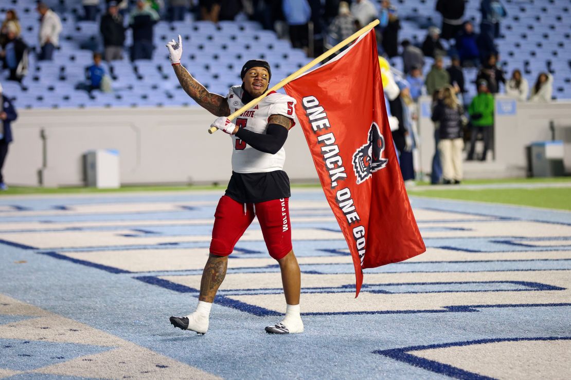 Kaufman carries a flag in the end zone after the game.