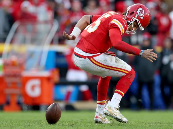 Kansas City Chiefs quarterback Patrick Mahomes recovers his fumble during a game against the Las Vegas Raiders at Arrowhead Stadium in Kansas City, Missouri, on Friday, November 29. The Chiefs won 19-17 and became the first team to clinch a playoff spot this season.