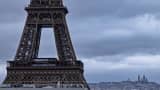 This photograph shows part of the Eiffel Tower with the Sacre-Coeur Basilica in the background, in Paris, on November 27, 2024. 