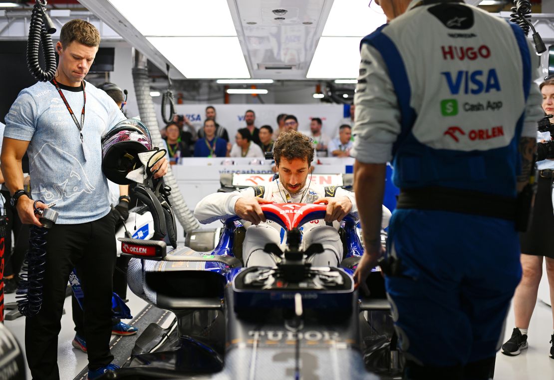 Daniel Ricciardo climbs into the cockpit of his VCARB 01 for the final time at the Singapore Grand Prix.