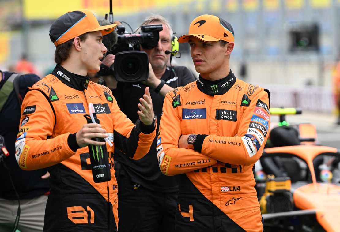 McLaren's  Oscar Piastri (L) and Norris talk after the qualifying session at the Hungarian Grand Prix.